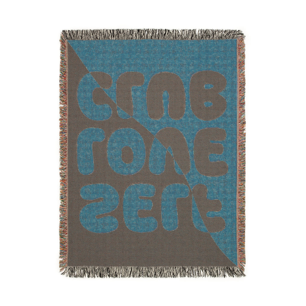 Woven blanket with a "SELF LOVE CLUB" pattern on a white background